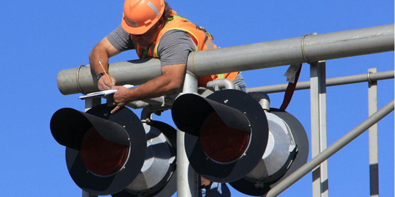 employee working on a light signal