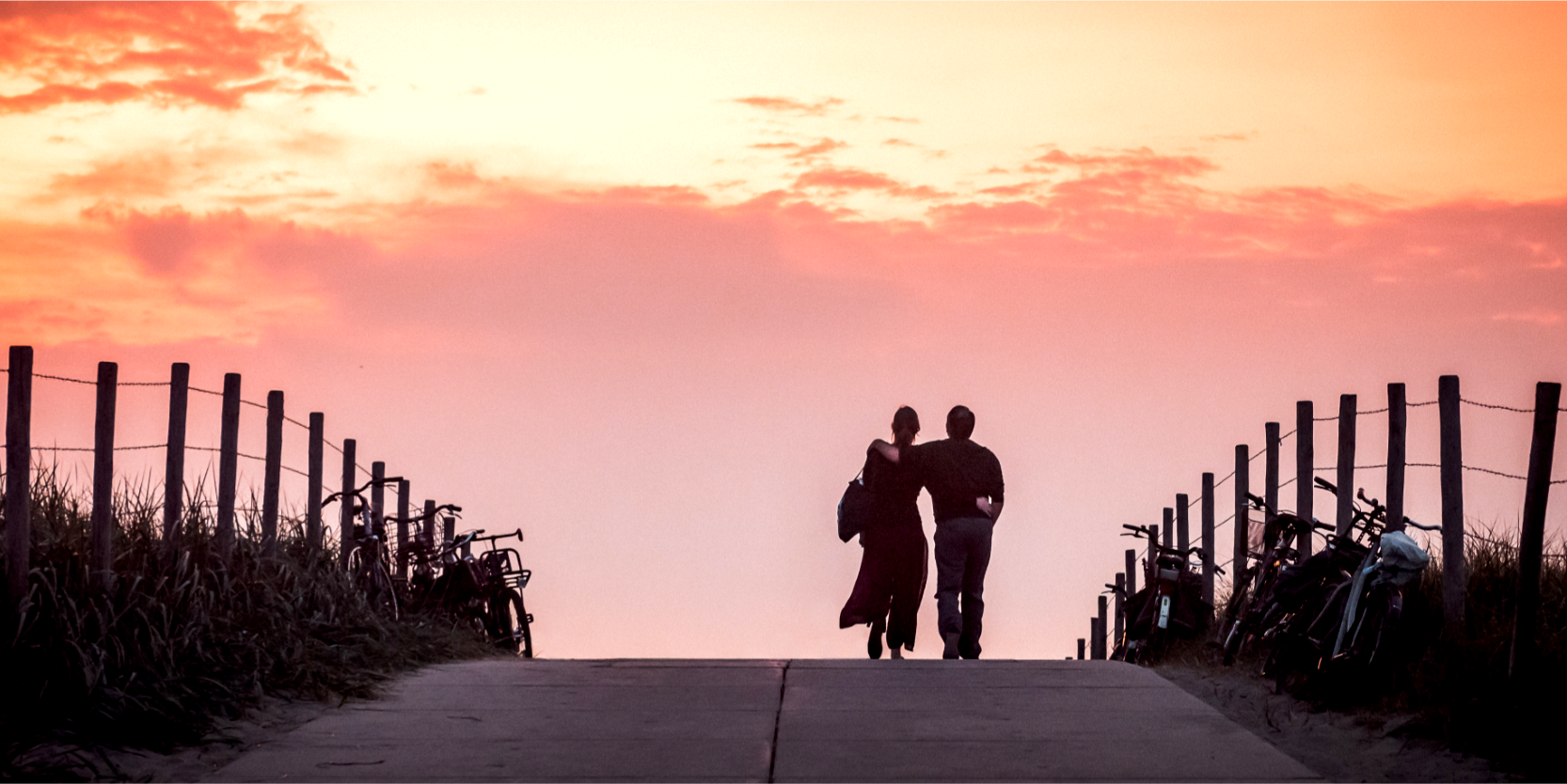 couple walking into sunset